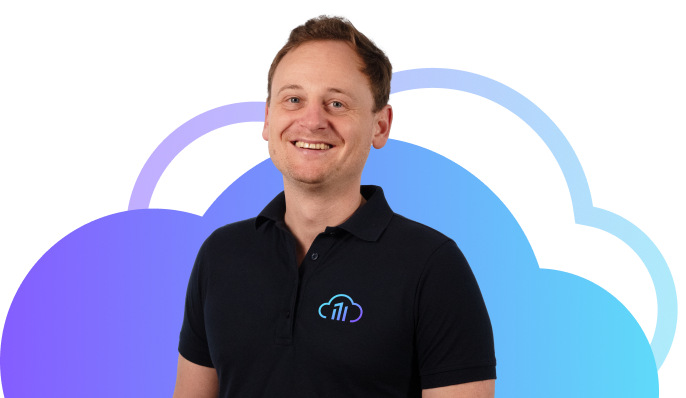 Portrait photo of Simon Spitznagel, smiling in a friendly manner, wearing a black polo shirt and company logo.